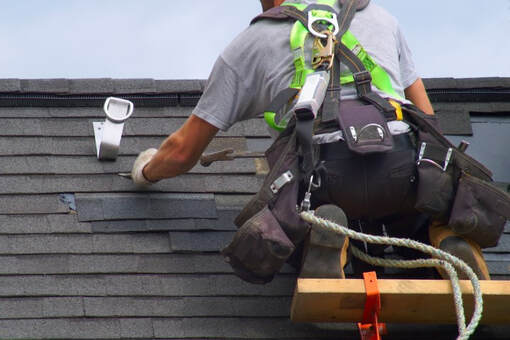 An image of a person working on a roofing services