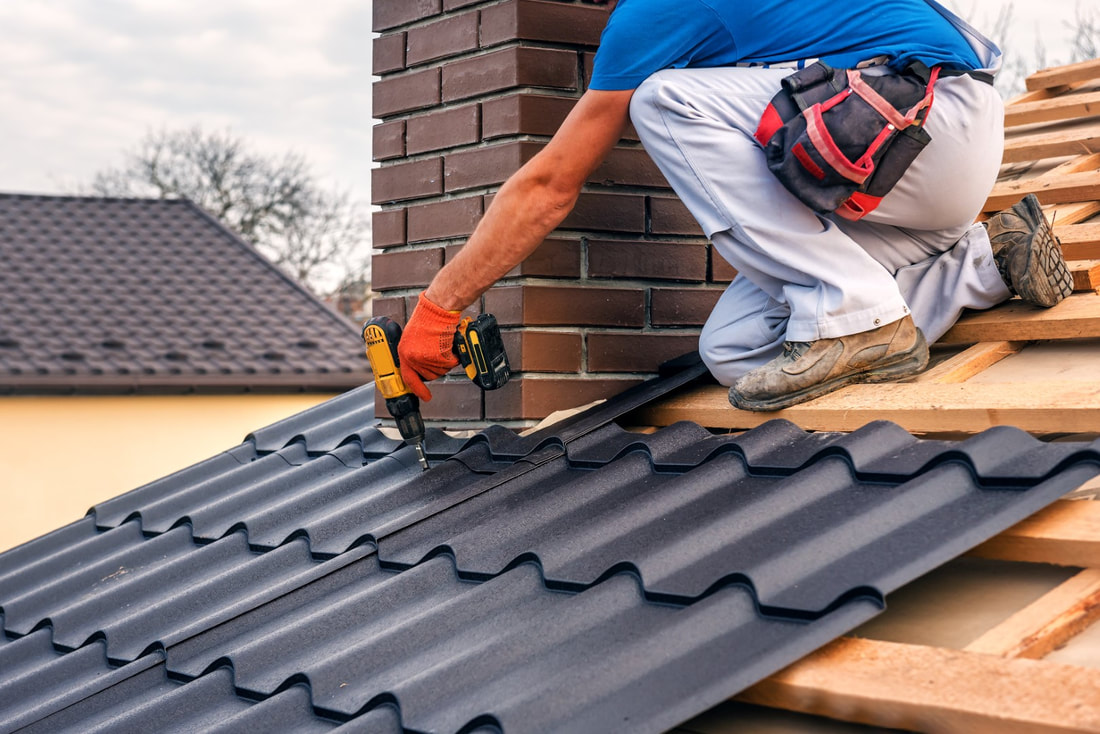 An image of a person working on a metal roofing service